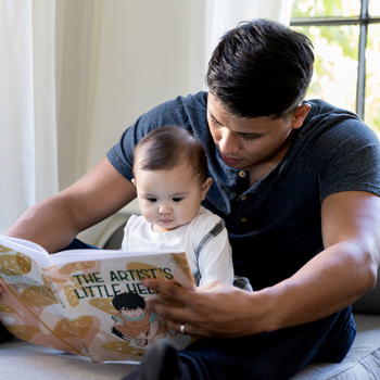A person reading to a baby.