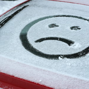 sad face drawn in the snow